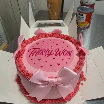 Pink birthday cake with a bow