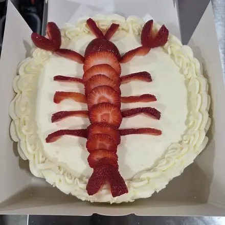 Cake decorated with a strawberry lobster