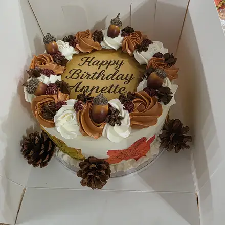 Autumn birthday cake with acorns and pinecones