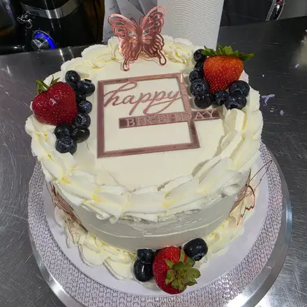 Cake with berries and a butterfly topper
