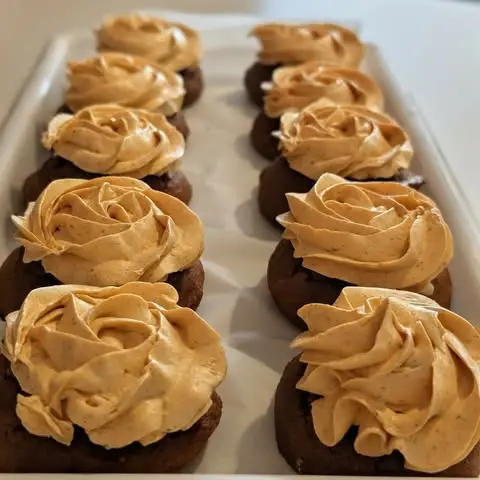 Rows of frosted peanut butter cupcakes